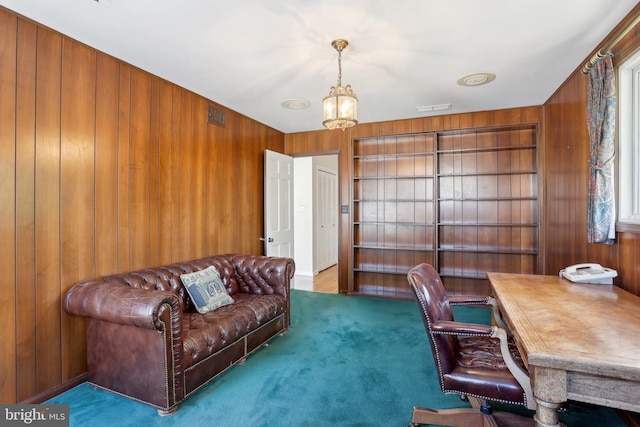 carpeted office with wood walls and built in shelves