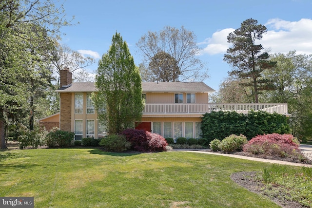 view of front of property with a chimney and a front yard