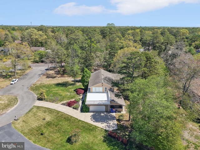 aerial view of property and surrounding area with a forest