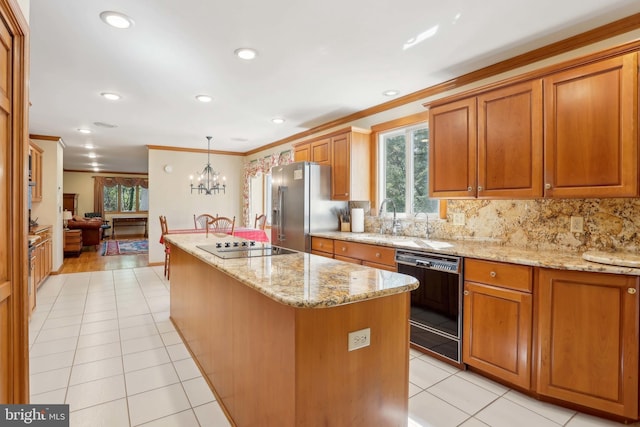 kitchen with black appliances, a kitchen island, crown molding, backsplash, and brown cabinets