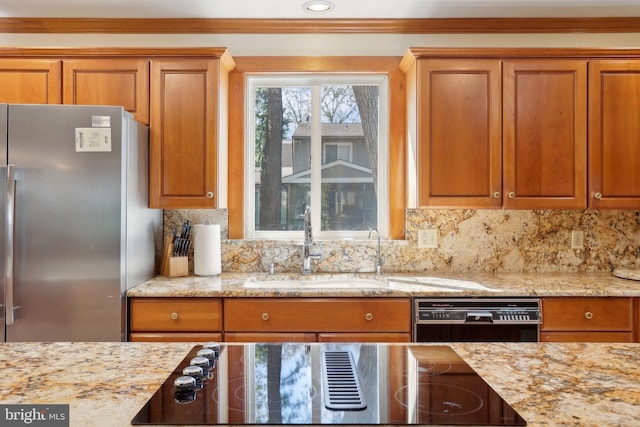 kitchen with black appliances, a sink, crown molding, decorative backsplash, and brown cabinetry