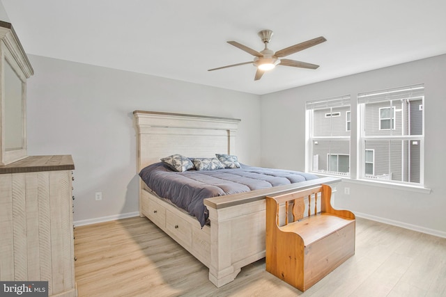 bedroom with baseboards, a ceiling fan, and light wood finished floors