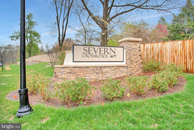 community sign featuring fence