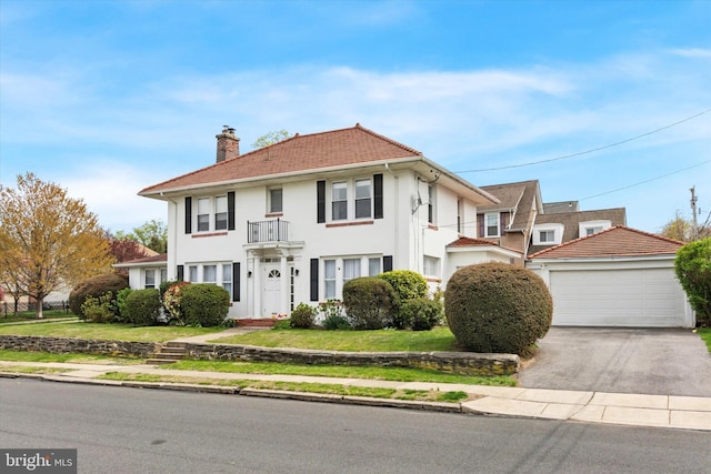 472 Gainsboro Rd, Drexel Hill, PA 19026 - colonial inspired home featuring a chimney, a balcony, stucco siding, a detached garage, and a front yard