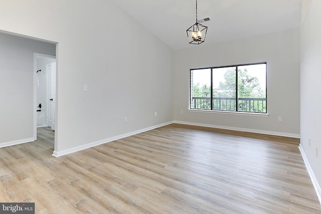 9552 Cannoneer Ct Unit 403, Manassas, VA 20110 - empty room with a chandelier, baseboards, light wood finished floors, and high vaulted ceiling