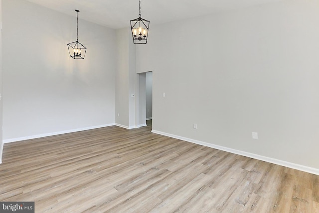 9552 Cannoneer Ct Unit 403, Manassas, VA 20110 - unfurnished dining area featuring a chandelier, wood finished floors, baseboards, and a high ceiling