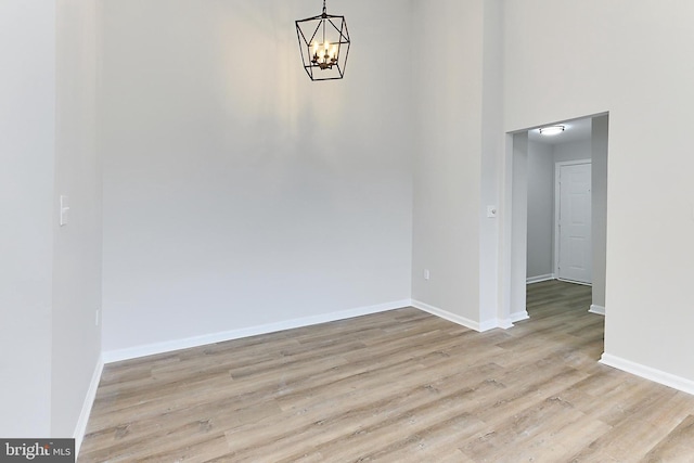 9552 Cannoneer Ct Unit 403, Manassas, VA 20110 - unfurnished dining area featuring a chandelier, wood finished floors, baseboards, and a high ceiling