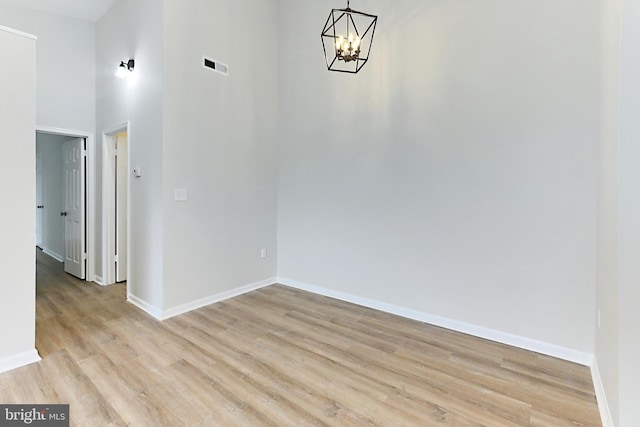 9552 Cannoneer Ct Unit 403, Manassas, VA 20110 - unfurnished dining area featuring a chandelier, baseboards, light wood-type flooring, and a towering ceiling