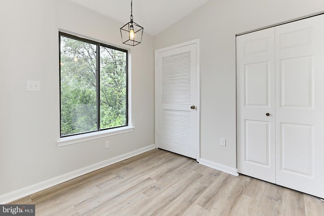 9552 Cannoneer Ct Unit 403, Manassas, VA 20110 - unfurnished dining area with light wood-style flooring, lofted ceiling, and baseboards