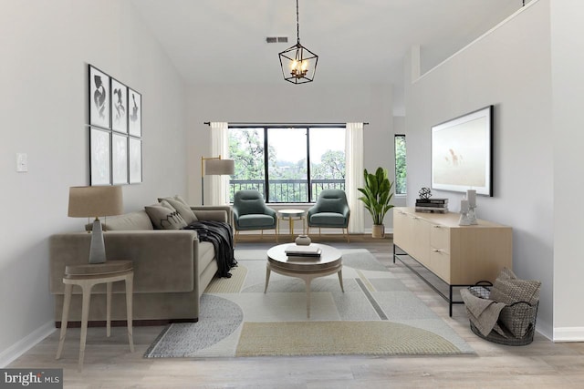 9552 Cannoneer Ct Unit 403, Manassas, VA 20110 - living area featuring baseboards, wood finished floors, a high ceiling, and a chandelier