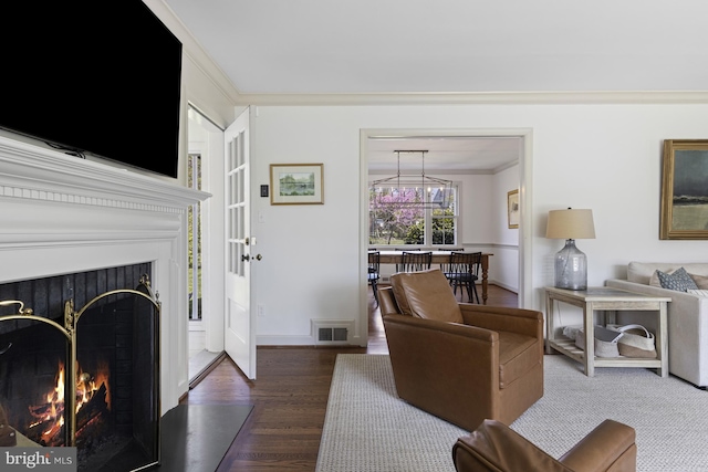 707 Greenwood Rd, Wilmington, DE 19807 - living room featuring ornamental molding, a lit fireplace, wood finished floors, and visible vents