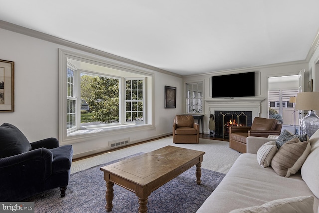 707 Greenwood Rd, Wilmington, DE 19807 - carpeted living area featuring a fireplace with flush hearth, plenty of natural light, visible vents, and ornamental molding