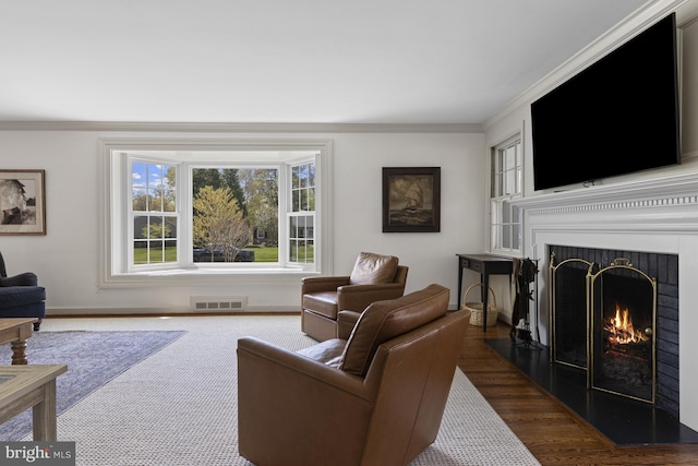 707 Greenwood Rd, Wilmington, DE 19807 - living area with a fireplace with flush hearth, baseboards, ornamental molding, and visible vents