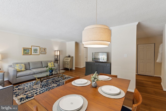 dining area featuring a textured ceiling and wood finished floors