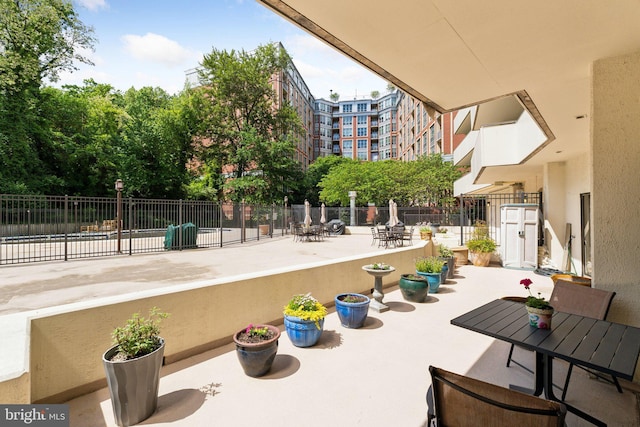 view of home's community featuring fence and a patio area