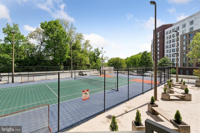 view of tennis court with fence