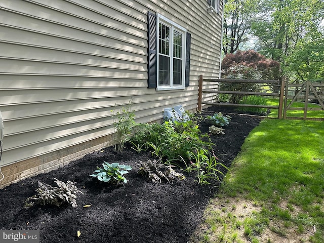 view of property exterior featuring a lawn and fence