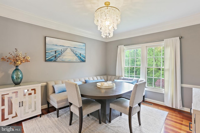 11373 Bishops Gate Ln, Laurel, MD 20723 - dining space with a chandelier, crown molding, wood finished floors, and baseboards