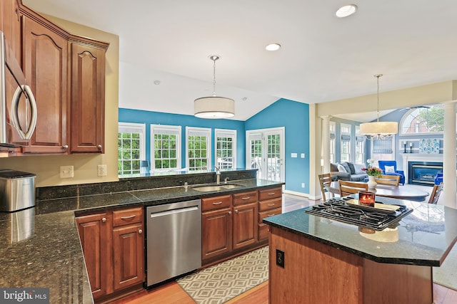 11373 Bishops Gate Ln, Laurel, MD 20723 - kitchen featuring appliances with stainless steel finishes, a sink, open floor plan, a glass covered fireplace, and a peninsula