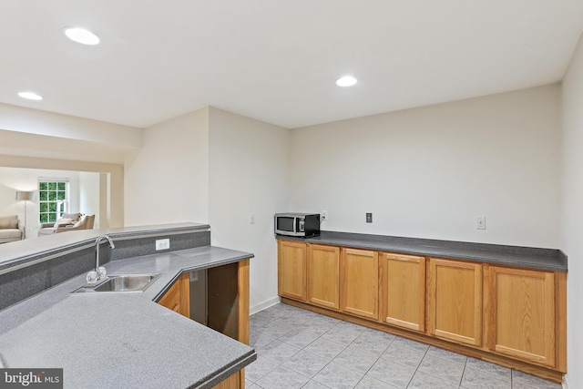 11373 Bishops Gate Ln, Laurel, MD 20723 - kitchen with stainless steel microwave, a sink, light tile patterned floors, recessed lighting, and dark countertops