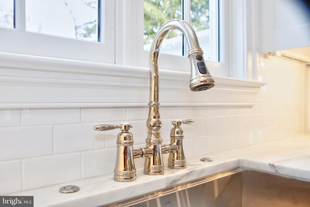 13 Sugarvale Way, Lutherville Timonium, MD 21093 - details featuring backsplash, light stone countertops, and a sink