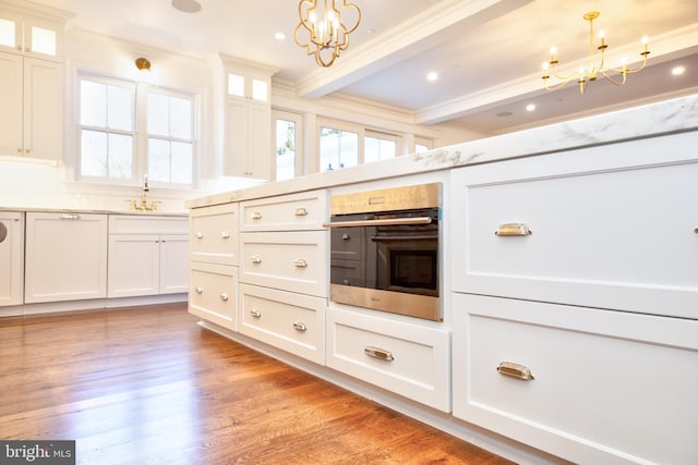 13 Sugarvale Way, Lutherville Timonium, MD 21093 - kitchen featuring plenty of natural light, stainless steel oven, an inviting chandelier, beamed ceiling, and white cabinetry