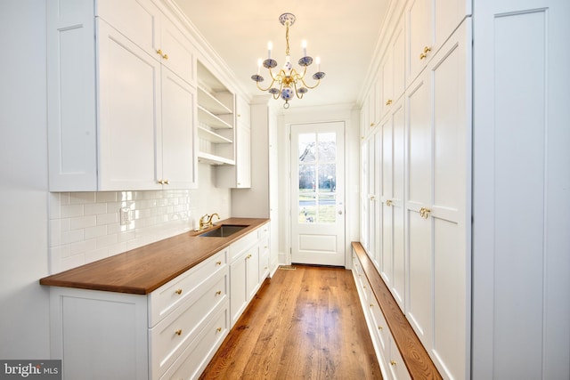 13 Sugarvale Way, Lutherville Timonium, MD 21093 - interior space with an inviting chandelier, wood finished floors, a sink, and crown molding