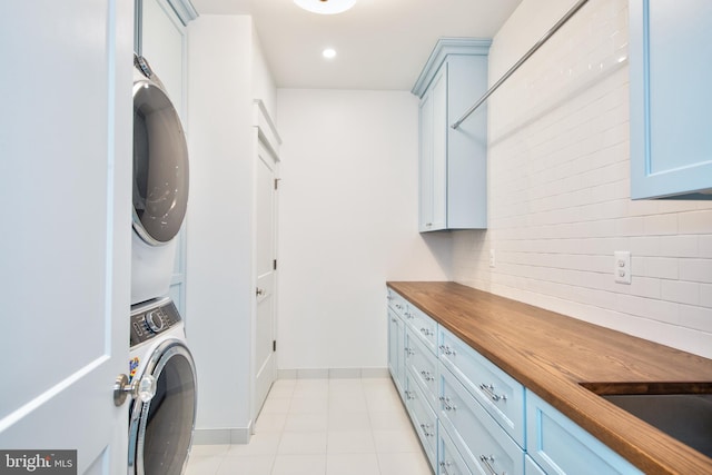 13 Sugarvale Way, Lutherville Timonium, MD 21093 - laundry area featuring stacked washer / dryer, light tile patterned floors, cabinet space, baseboards, and recessed lighting