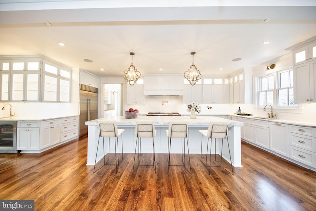 13 Sugarvale Way, Lutherville Timonium, MD 21093 - kitchen featuring beverage cooler, white cabinetry, appliances with stainless steel finishes, and tasteful backsplash