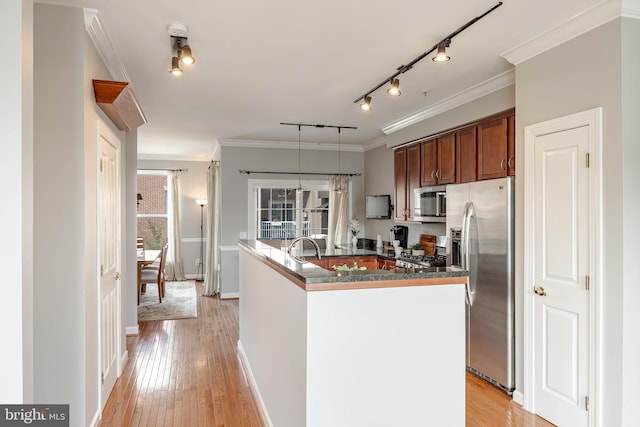 2331 Cambridge Walk, Baltimore, MD 21224 - kitchen with light wood-type flooring, appliances with stainless steel finishes, an island with sink, and ornamental molding