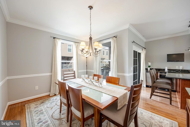 2331 Cambridge Walk, Baltimore, MD 21224 - dining space with baseboards, a notable chandelier, crown molding, and light wood-type flooring