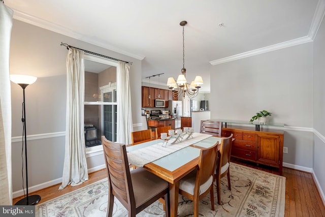 2331 Cambridge Walk, Baltimore, MD 21224 - dining area featuring a chandelier, light wood finished floors, baseboards, and ornamental molding