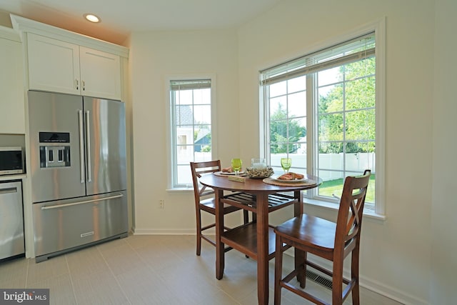 dining space featuring baseboards and recessed lighting