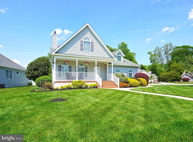 view of front facade featuring a porch, a chimney, and a front lawn