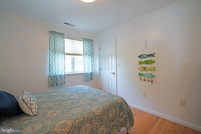 bedroom featuring hardwood / wood-style floors and baseboards