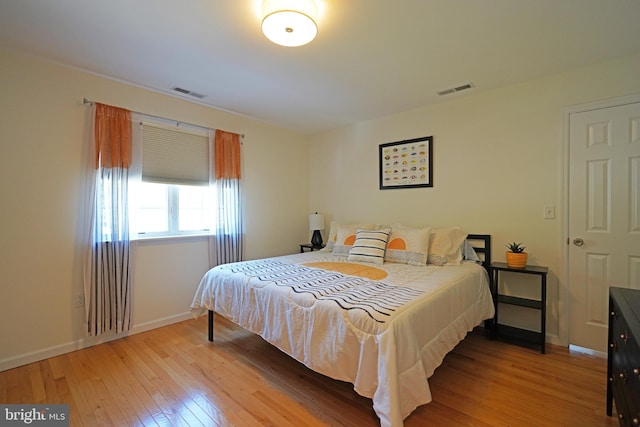 bedroom featuring hardwood / wood-style flooring and baseboards