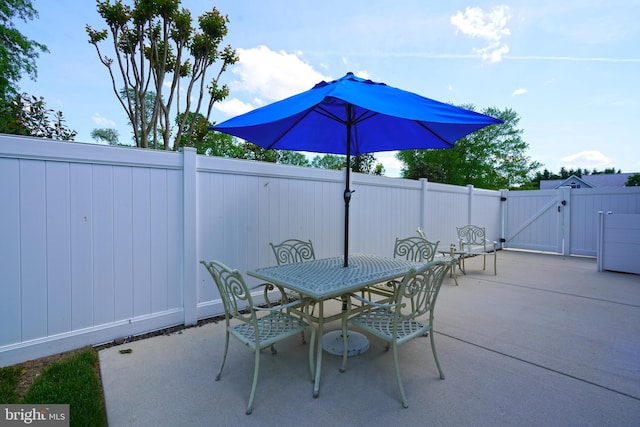 view of patio / terrace featuring a gate, outdoor dining area, and fence