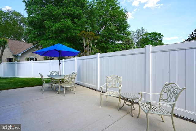 view of patio / terrace with outdoor dining area and fence