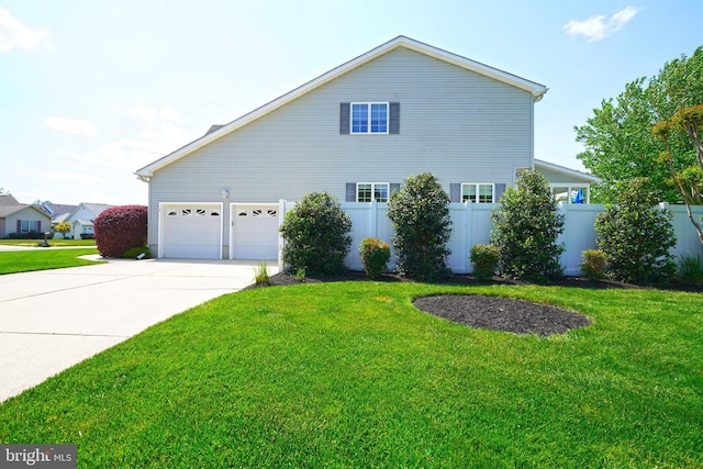 view of side of property with concrete driveway and a garage