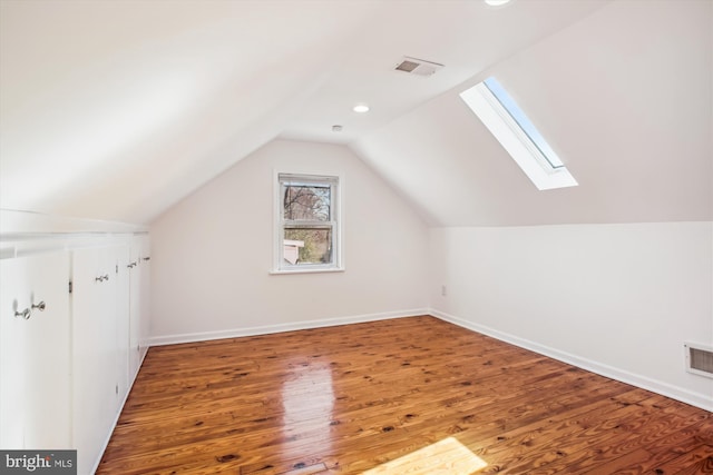 6813 Chestnut Ave, Falls Church, VA 22042 - additional living space with baseboards, vaulted ceiling with skylight, wood finished floors, and visible vents