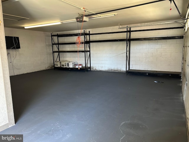 6813 Chestnut Ave, Falls Church, VA 22042 - garage featuring a garage door opener and concrete block wall