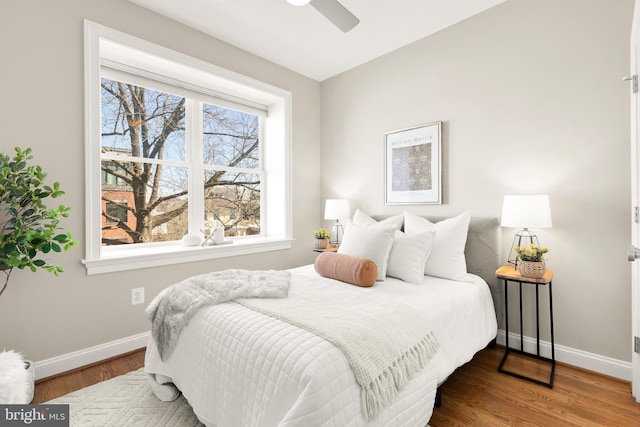 bedroom featuring baseboards and wood finished floors