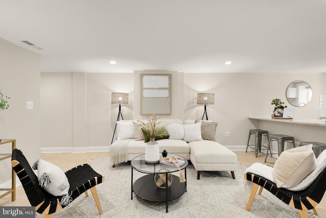 living room with baseboards, visible vents, and recessed lighting