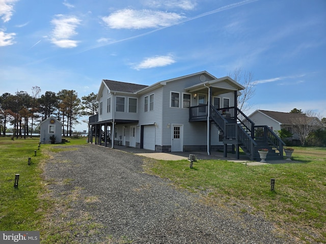 2508 Old House Point Rd, Fishing Creek, MD 21634 - view of side of home with a yard, an attached garage, gravel driveway, and stairway