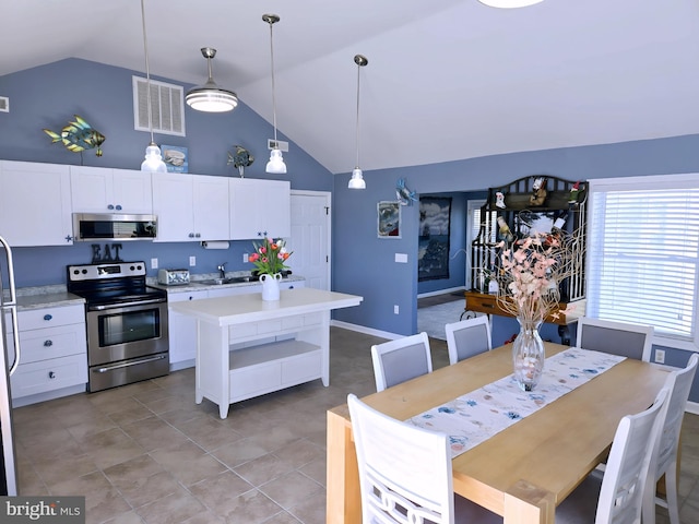 2508 Old House Point Rd, Fishing Creek, MD 21634 - kitchen with visible vents, high vaulted ceiling, light countertops, a sink, and appliances with stainless steel finishes