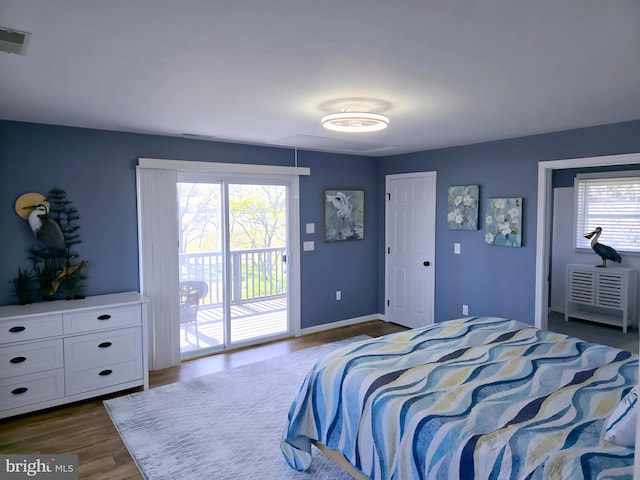 2508 Old House Point Rd, Fishing Creek, MD 21634 - bedroom featuring dark wood-style flooring, access to outside, attic access, baseboards, and visible vents