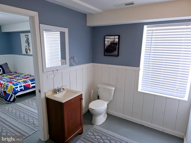 2508 Old House Point Rd, Fishing Creek, MD 21634 - bathroom with visible vents, vanity, wainscoting, finished concrete flooring, and toilet
