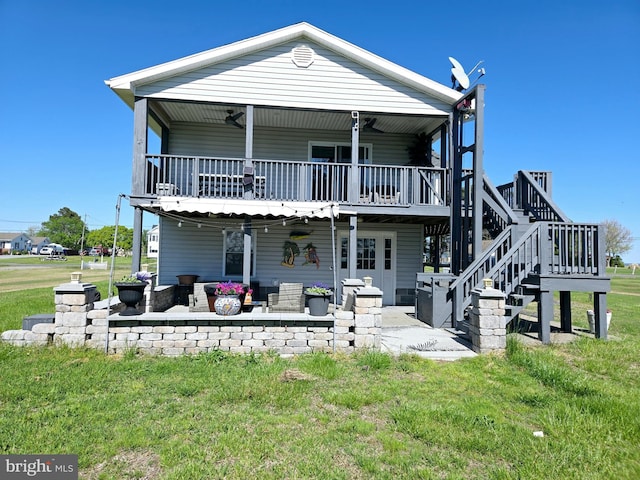2508 Old House Point Rd, Fishing Creek, MD 21634 - rear view of house with a lawn, a deck, a patio area, stairway, and outdoor lounge area