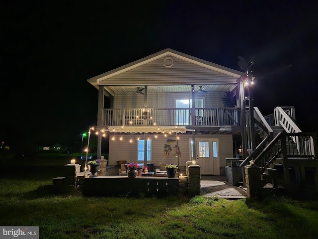 2508 Old House Point Rd, Fishing Creek, MD 21634 - back of house at twilight featuring a lawn, a patio, stairway, and a wooden deck