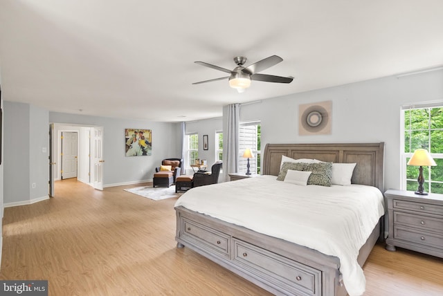 bedroom featuring light wood-type flooring, baseboards, and a ceiling fan